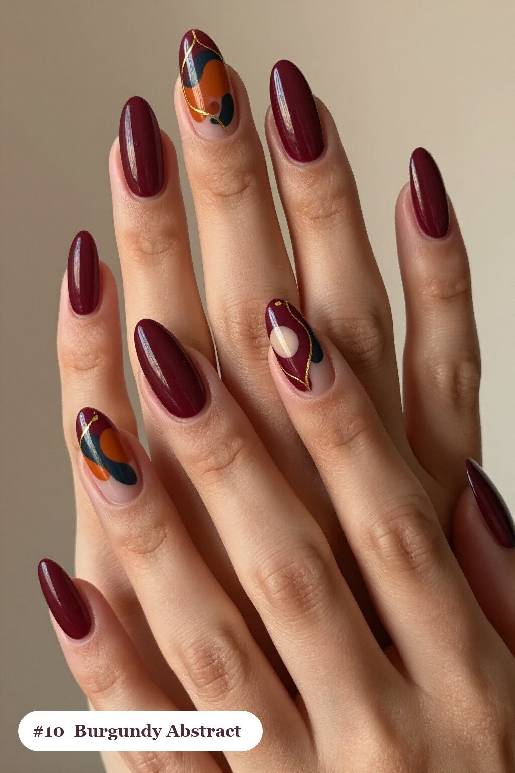 Burgundy Almond Nails with Abstract Gold-Detailed Art - fall nails Burgundy Almond Nails with Abstract Gold-Detailed Art - fall nails