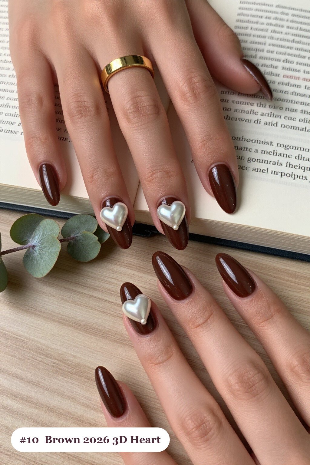 Long coffin chocolate brown 2026 nails with chunky 3D gel hearts and pearls on three nails, perfect for autumn - autumn nails 2026