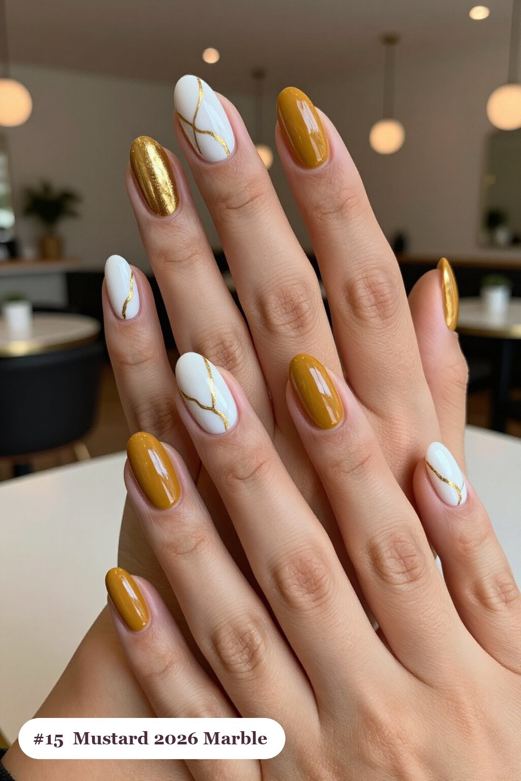 Medium oval mustard 2026 nails with bold marble veins in white and gold across every nail, perfect for autumn - autumn nails 2026