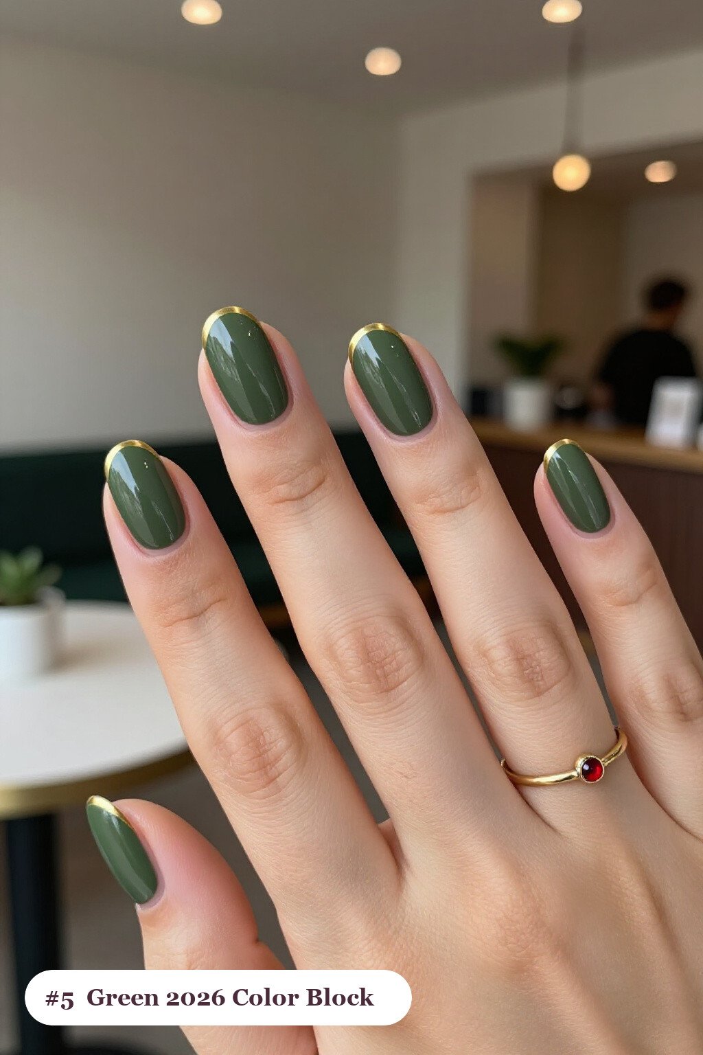 Medium oval olive green 2026 nails in a colour-block design split diagonally with a thin gold line, perfect for autumn - autumn nails 2026