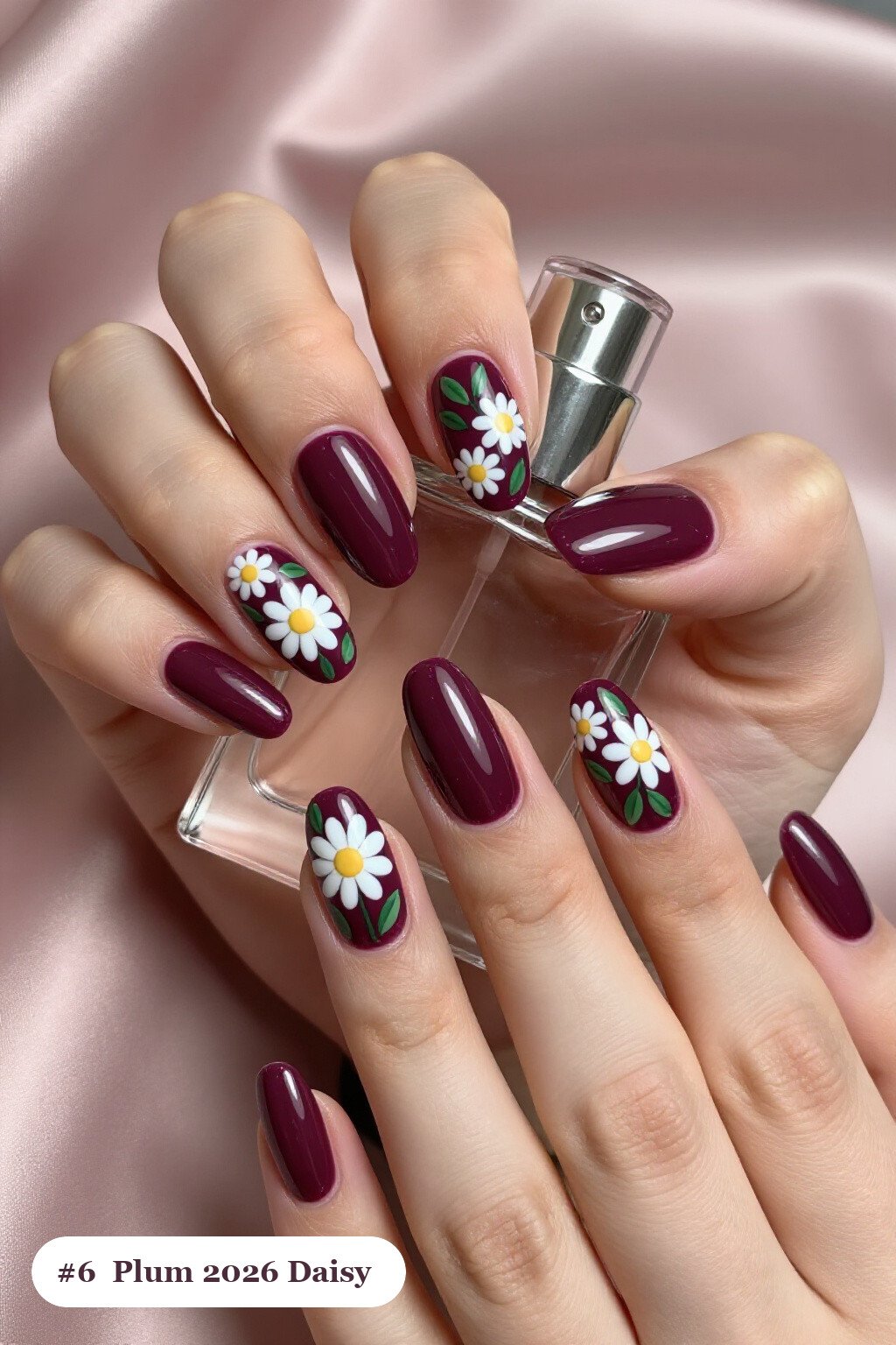 Medium square deep plum 2026 nails with hand-painted daisies and green leaves across every nail, perfect for autumn - autumn nails 2026