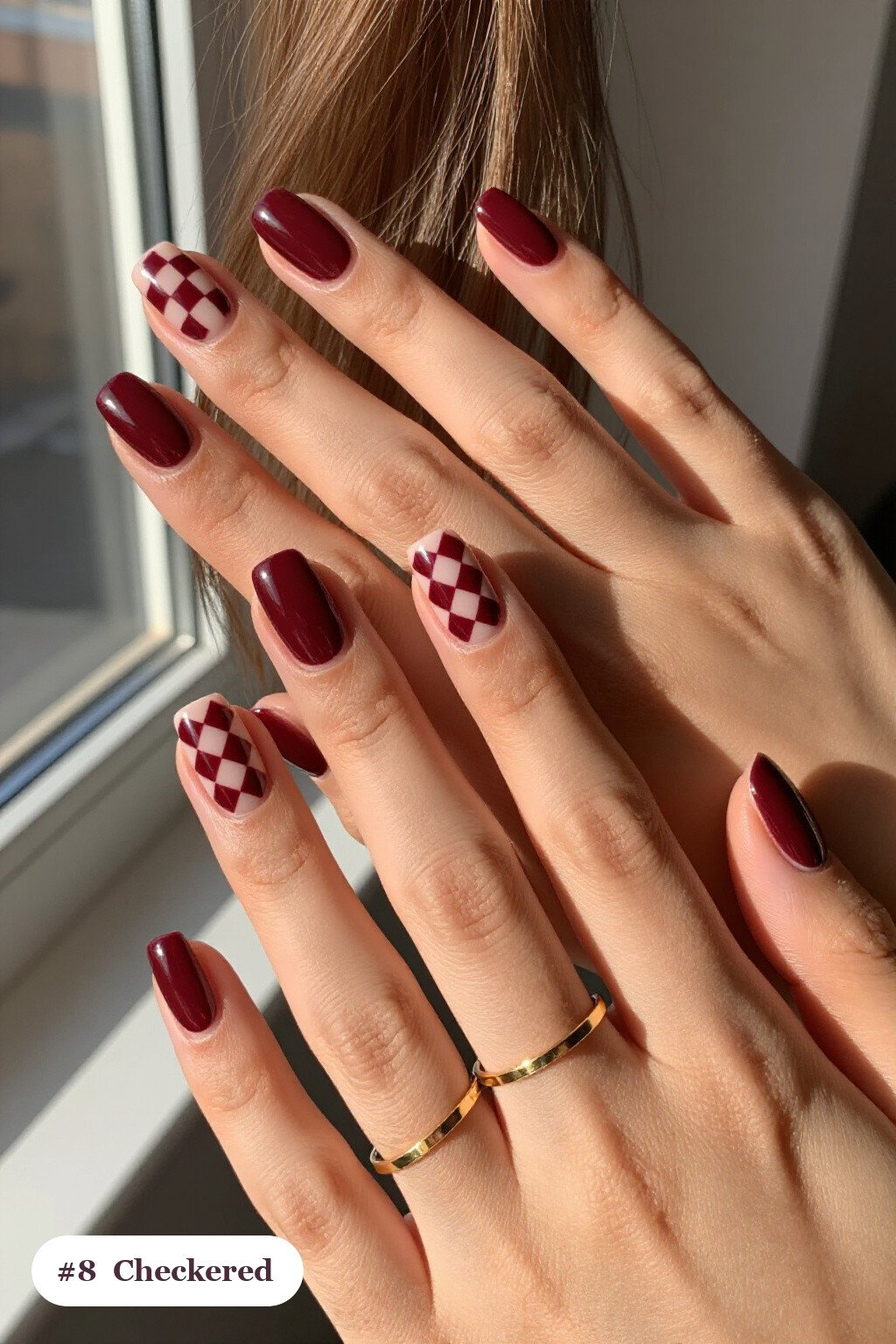 Short square burgundy 2026 nails with a bold checkerboard pattern on two accent nails and solid colour on the rest, perfect for autumn - autumn nails 2026