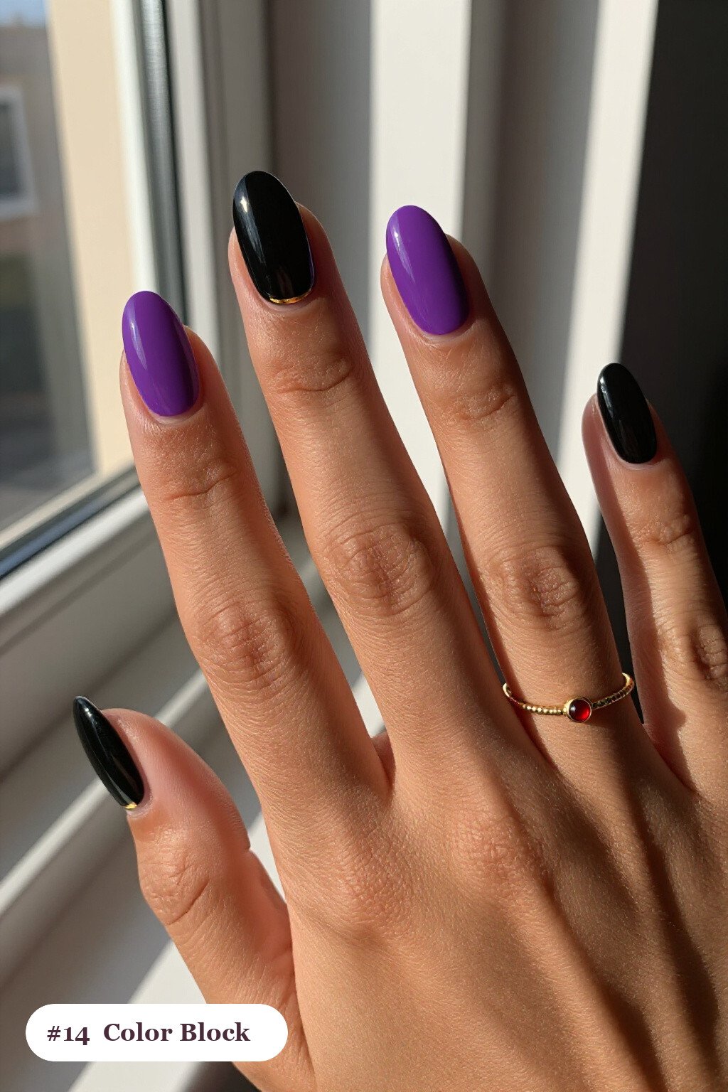 Medium coffin black purple nails in a colour-block design split diagonally with a thin gold line, with gold details, perfect for halloween - black and purple halloween nail designs