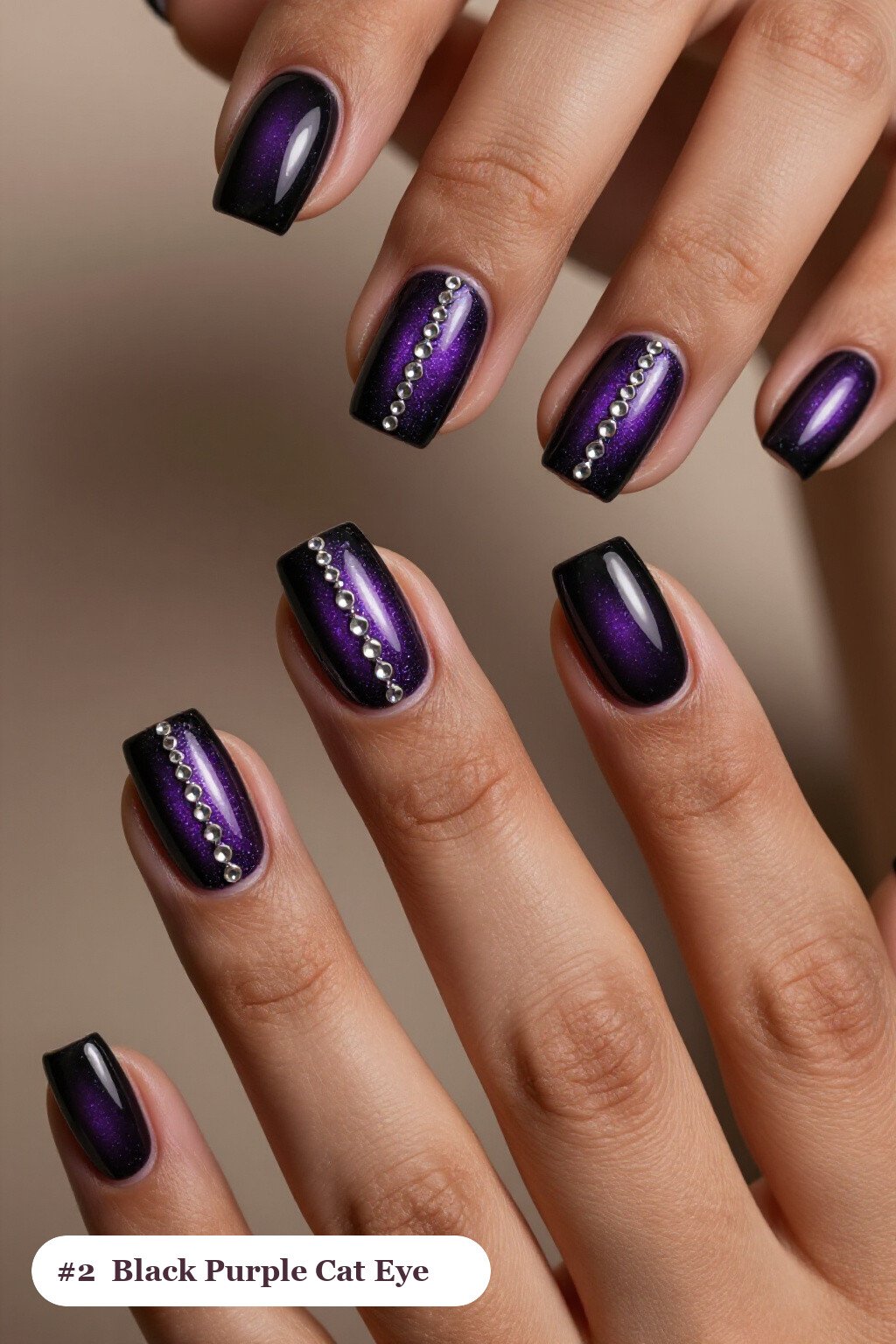 Short square black purple nails with a glowing shimmer band of light running down the centre of each nail like a gemstone, with silver details, perfect for halloween - black and purple halloween nail designs