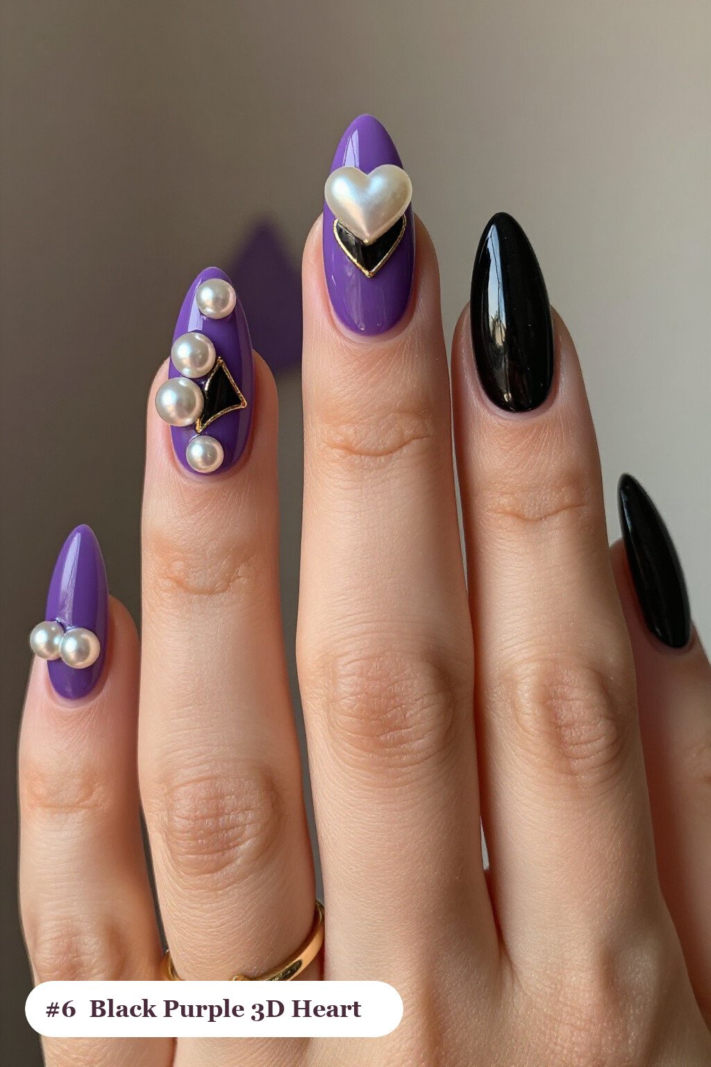 Long almond black purple nails with chunky 3D gel hearts and pearls on three nails, with gold details, perfect for halloween - black and purple halloween nail designs