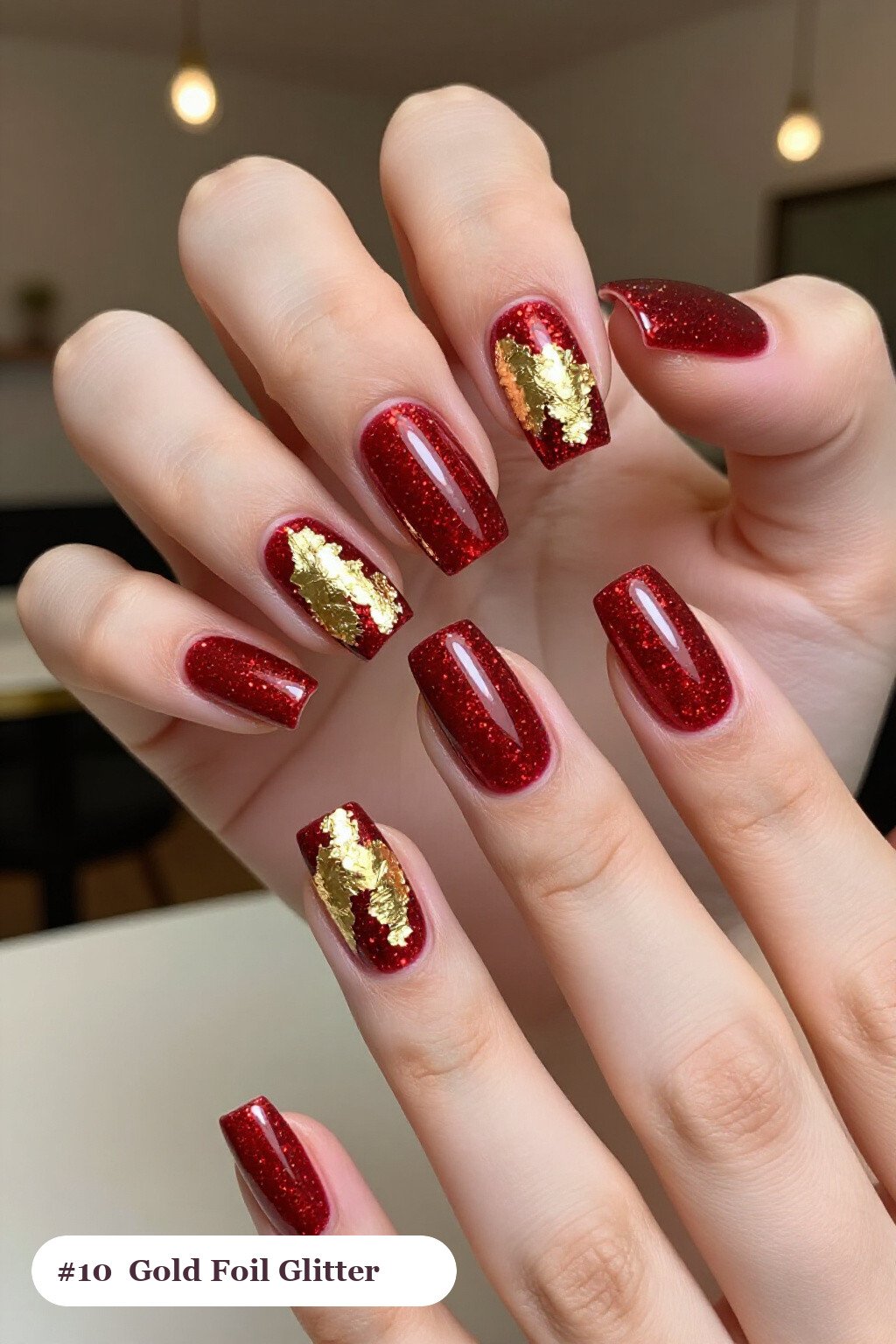 Long square cherry red glitter nails with sparkling glitter clearly visible on every nail, styled with dense gold foil flakes and gold leaf scattered across every nail, perfect for christmas - christmas glitter nails