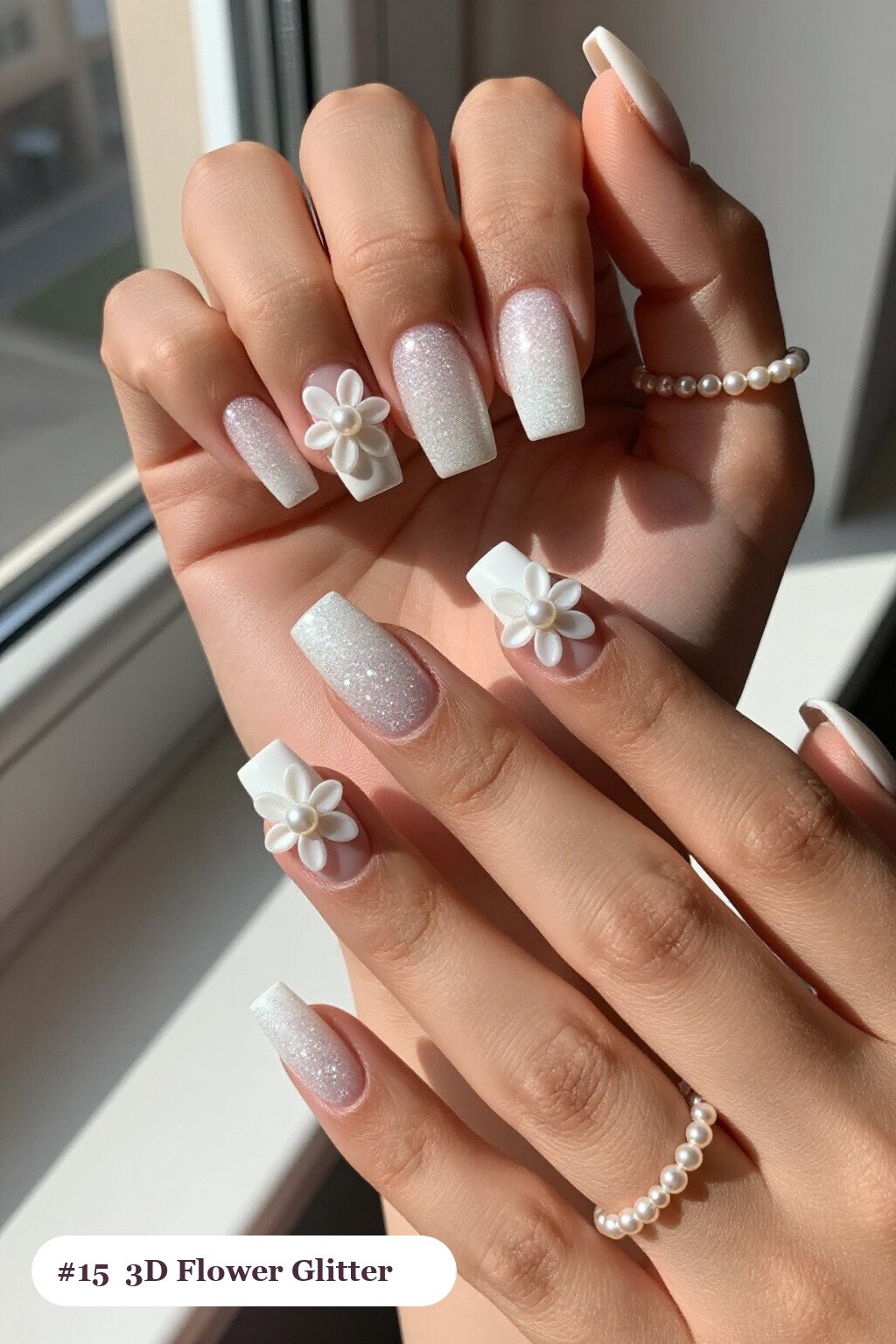 Medium square snow white glitter nails with sparkling glitter clearly visible on every nail, styled with raised 3D flowers with pearl centres on two accent nails, perfect for christmas - christmas glitter nails