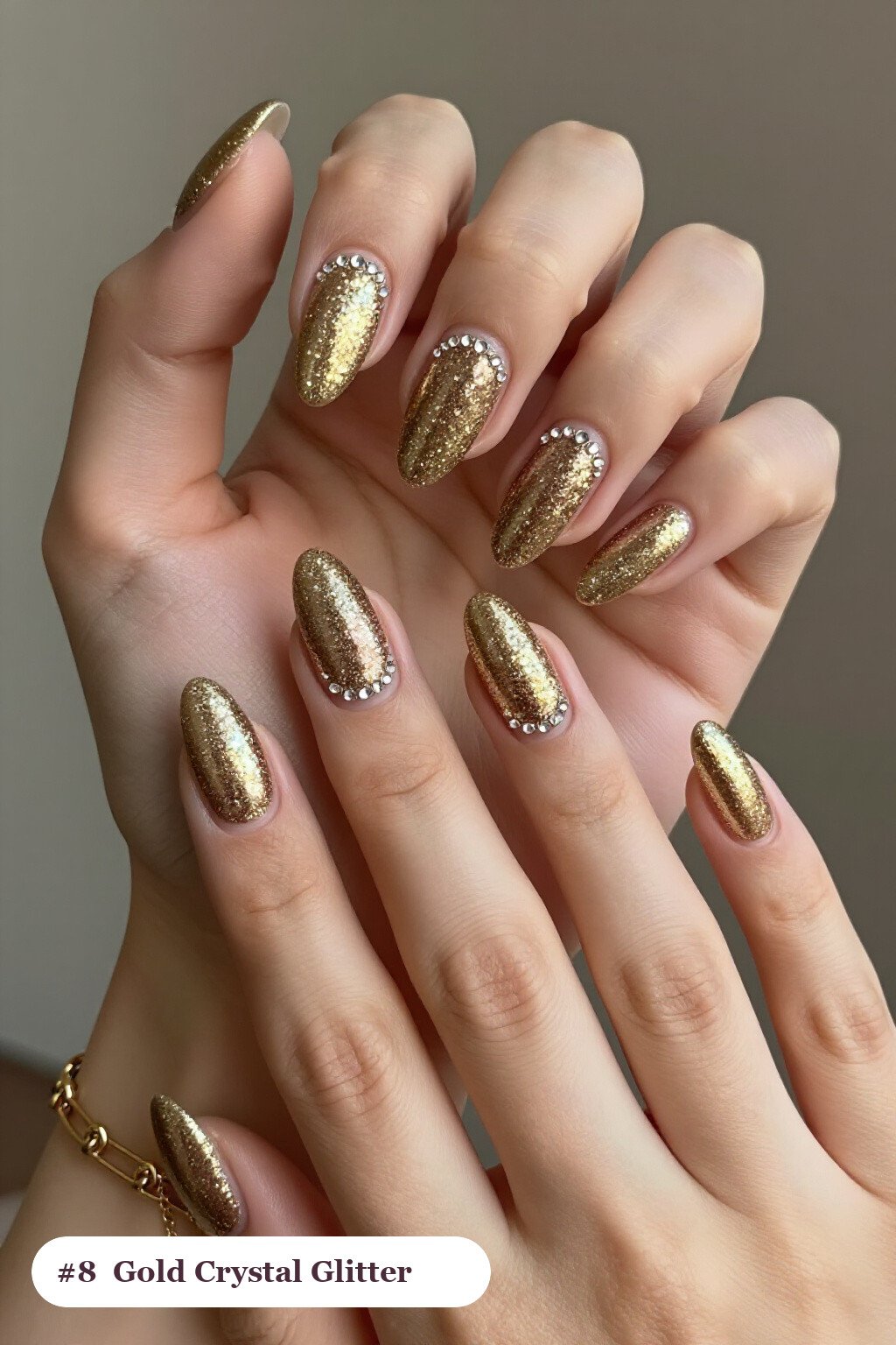 Medium almond gold glitter nails with sparkling glitter clearly visible on every nail, styled with rows of sparkling crystal rhinestones along the cuticle of every nail, perfect for christmas - christmas glitter nails