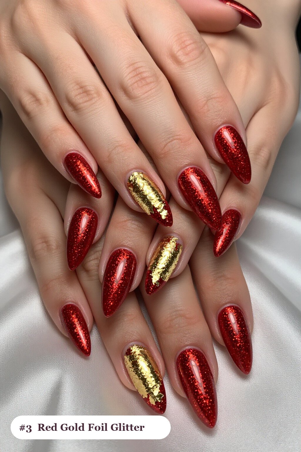 Long stiletto glitter red nails with sparkling glitter clearly visible on every nail, styled with dense gold foil flakes and gold leaf scattered across every nail, with gold details, perfect for christmas - christmas glitter nails red