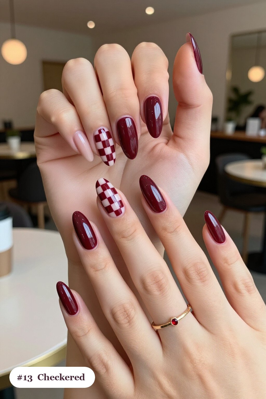 Burgundy Almond Nails with Bold Checkerboard Accent Pair - christmas manicure ideas 2026