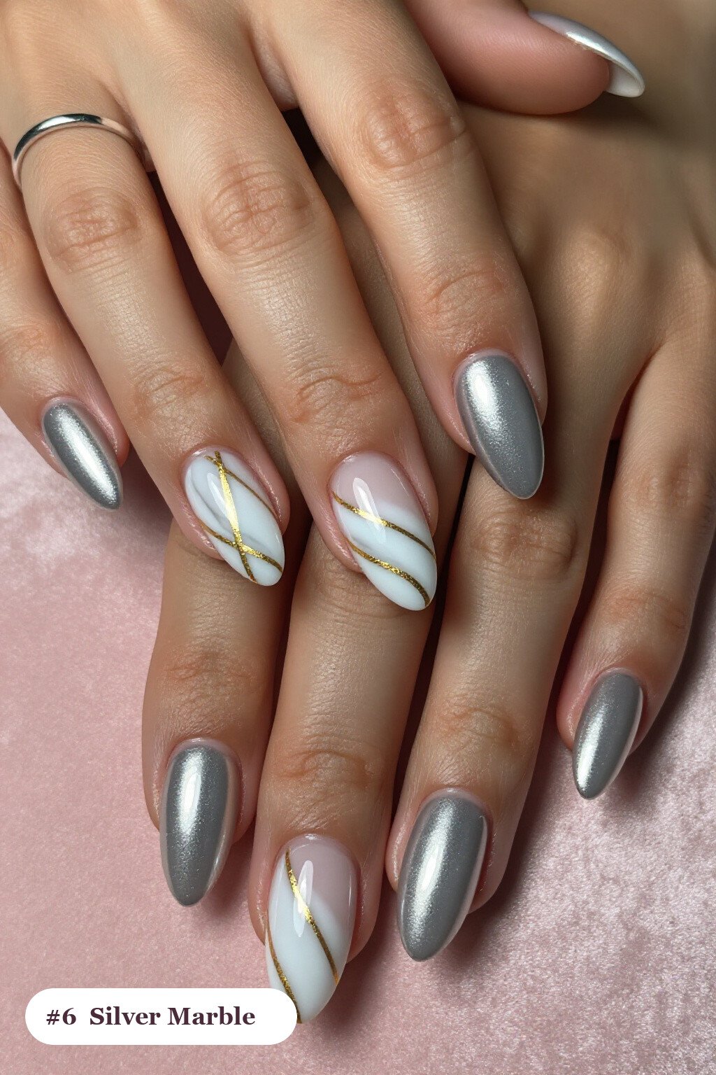 Medium almond silver nails with bold marble veins in white and gold across every nail, perfect for christmas - christmas nail designs holiday