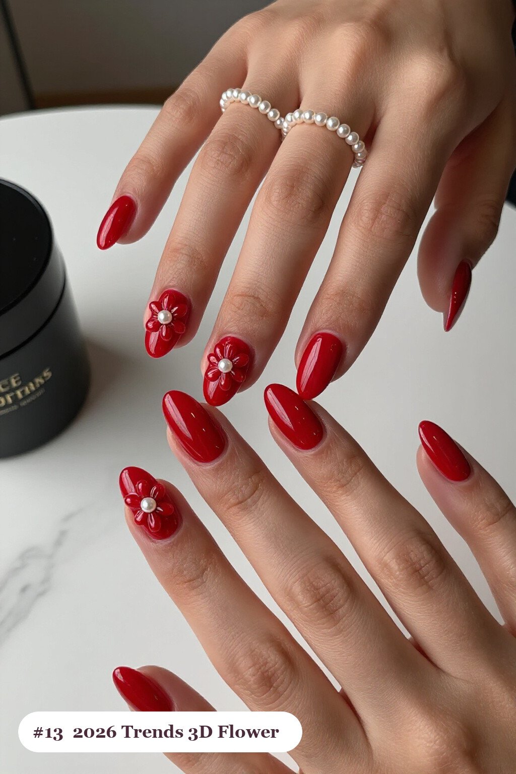 Medium coffin cherry red 2026 trends nails with raised 3D flowers with pearl centres on two accent nails, perfect for christmas - christmas nails 2026 trends