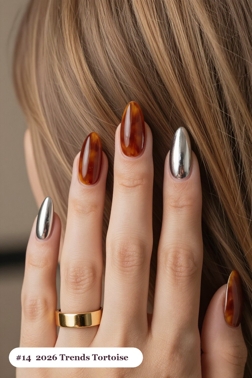 Long almond silver 2026 trends nails with glossy amber tortoiseshell on two accent nails, perfect for christmas - christmas nails 2026 trends
