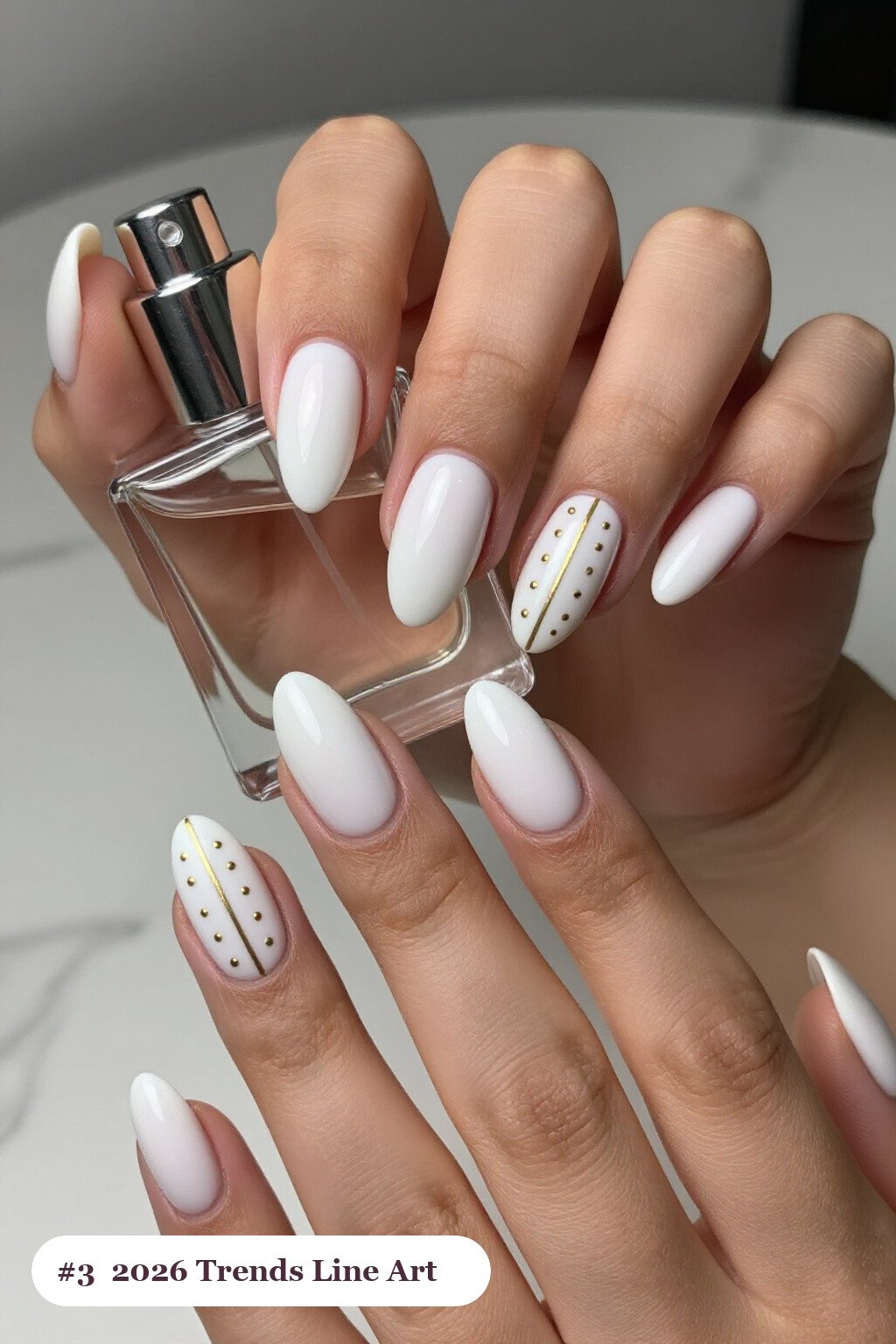 Medium coffin snow white 2026 trends nails with fine gold line art and tiny dots drawn across every nail, perfect for christmas - christmas nails 2026 trends