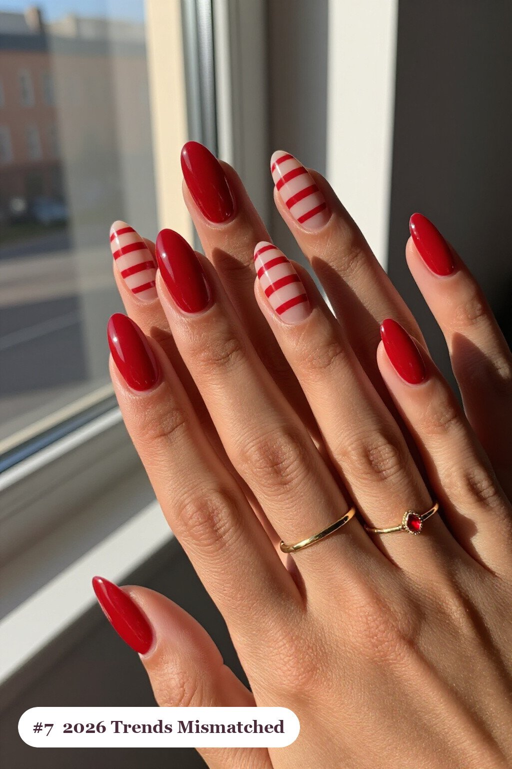 Medium almond cherry red 2026 trends nails as a mismatched set where every nail has a different pattern in the same colour story, perfect for christmas - christmas nails 2026 trends