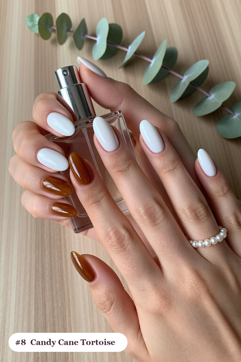 Snow‑White Oval Nails with Amber Tortoiseshell Accents - christmas nails candy cane