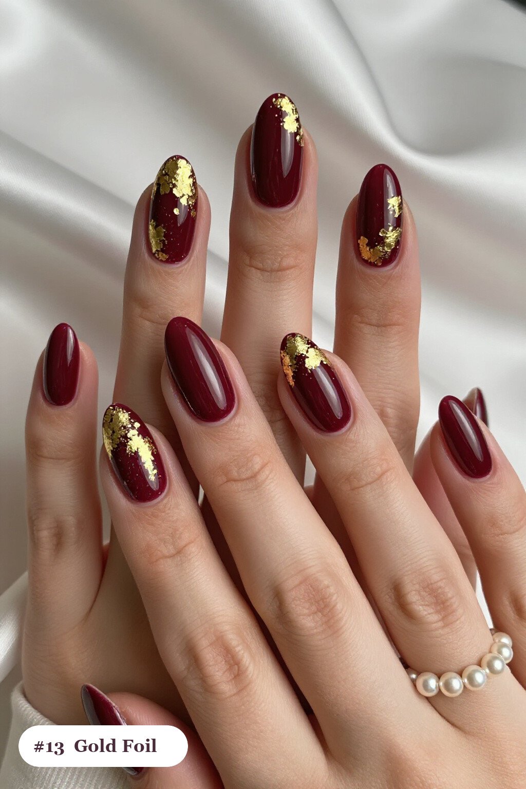 Burgundy Almond Nails Covered in Dense Gold Foil Flakes and Gold Leaf - christmas nails holly