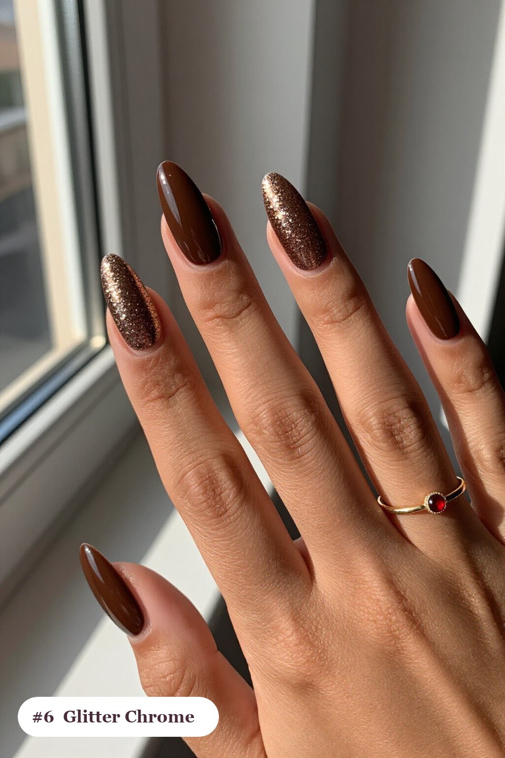 Long almond chocolate brown coffee chrome nails with a liquid chrome mirror finish clearly visible on every nail, styled with a sparkling glitter gradient rising from the cuticle - coffee chrome nails