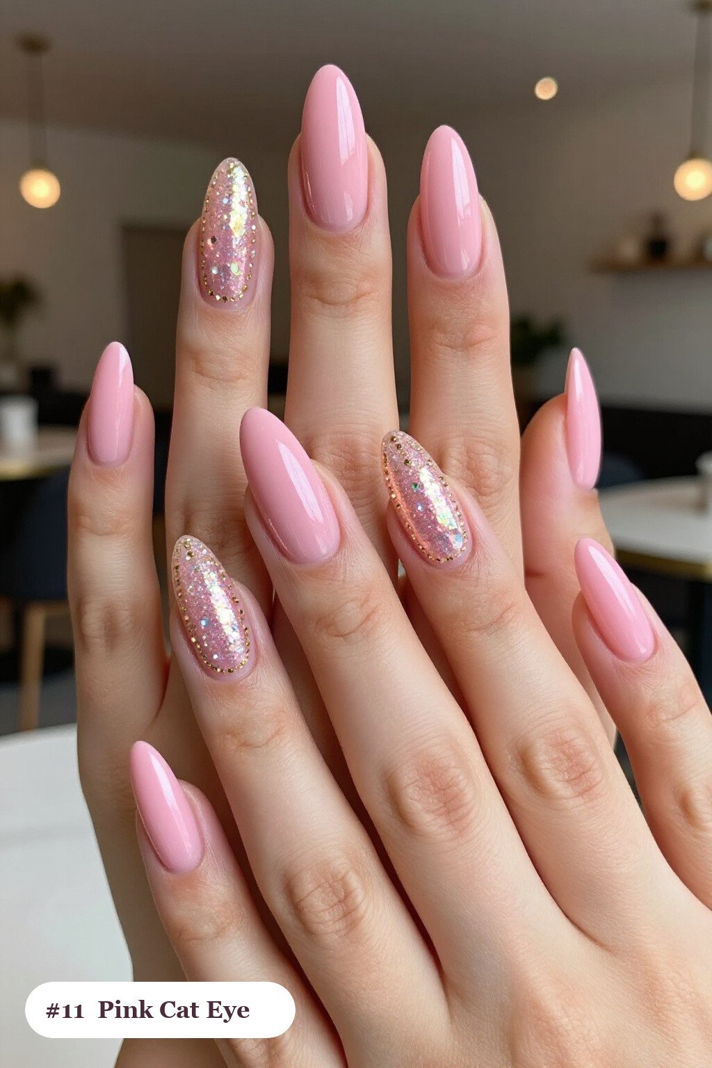 Long almond pink nails with a glowing shimmer band of light running down the centre of each nail like a gemstone, with gold details, perfect for halloween - cute halloween nails pink