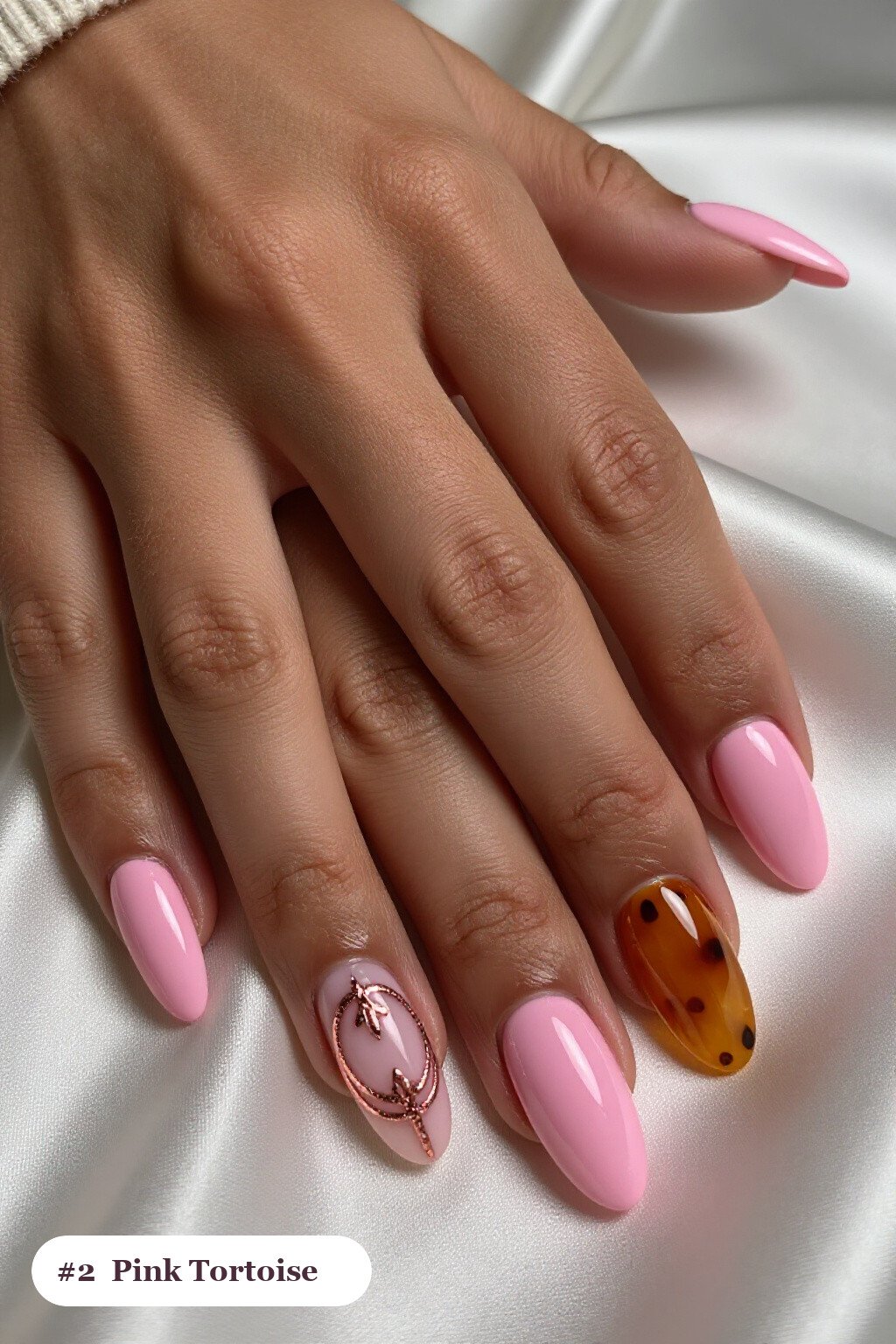 Medium almond pink nails with glossy amber tortoiseshell on two accent nails, with rose gold details, perfect for halloween - cute halloween nails pink