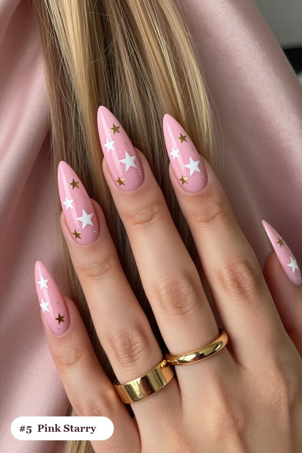Long stiletto pink nails with white and gold stars and sparkles painted on every nail, with silver details, perfect for halloween - cute halloween nails pink