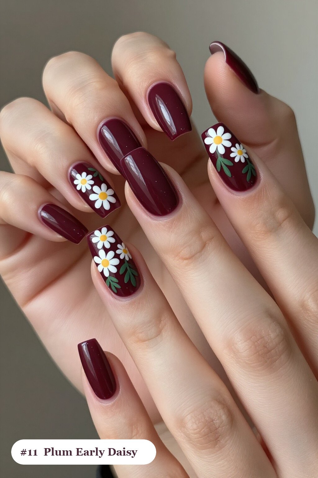 Long square deep plum early nails with hand-painted daisies and green leaves across every nail, perfect for fall - early fall nail designs