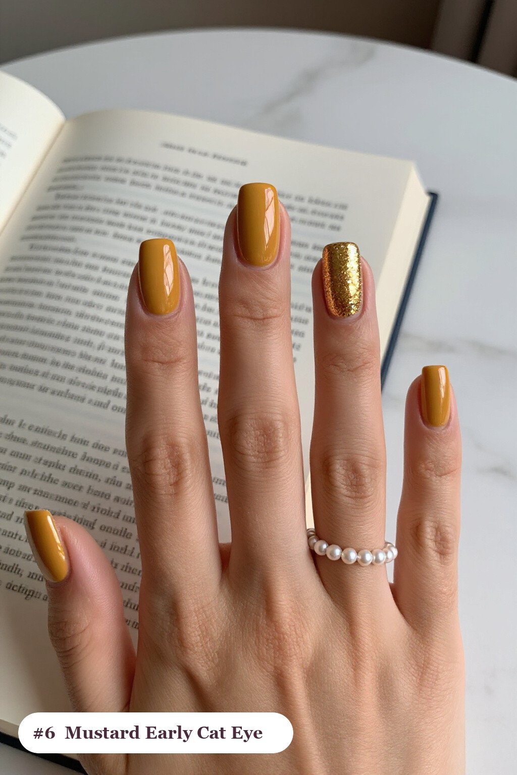 Short square mustard early nails with a glowing shimmer band of light running down the centre of each nail like a gemstone, perfect for fall - early fall nail designs