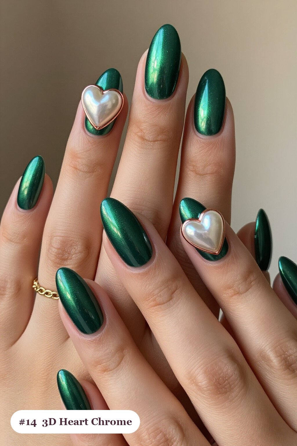 Medium almond emerald chrome nails with a liquid chrome mirror finish clearly visible on every nail, styled with chunky 3D gel hearts and pearls on three nails, with rose gold details - emerald chrome almond nails