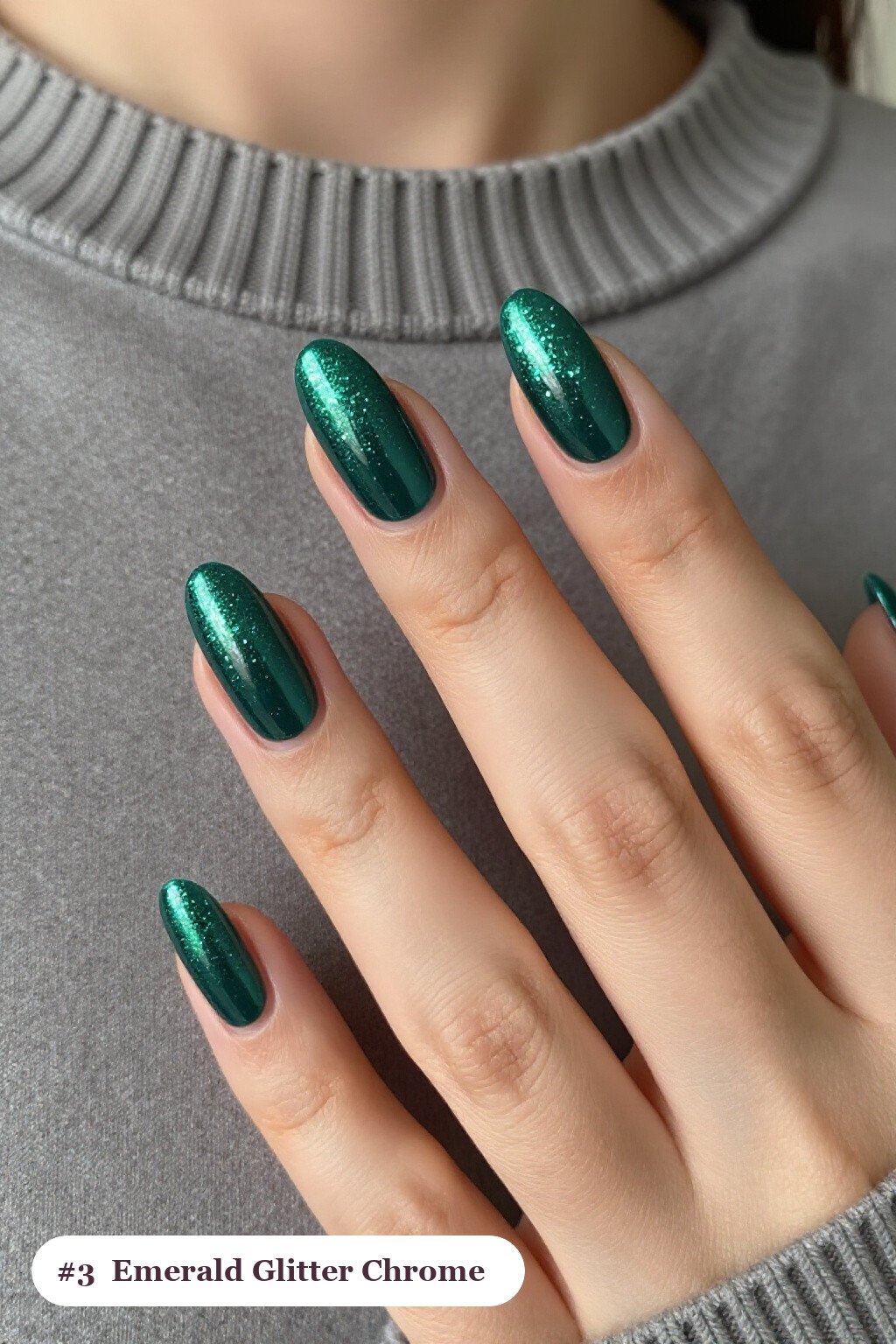 Medium almond emerald chrome nails with a liquid chrome mirror finish clearly visible on every nail, styled with a sparkling glitter gradient rising from the cuticle - emerald chrome almond nails