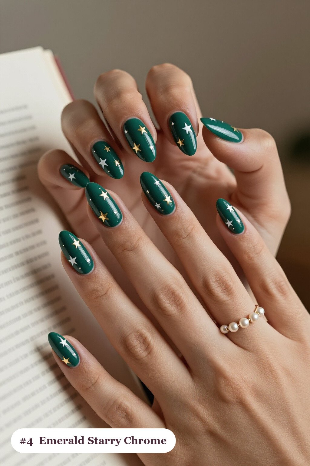 Medium almond emerald chrome nails with a liquid chrome mirror finish clearly visible on every nail, styled with white and gold stars and sparkles painted on every nail, with gold details - emerald chrome almond nails