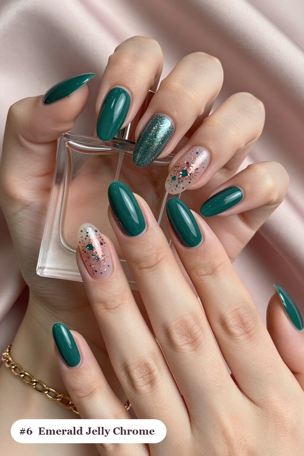 Medium almond emerald chrome nails with a liquid chrome mirror finish clearly visible on every nail, styled with a see-through jelly finish with encapsulated glitter, with rose gold details - emerald chrome almond nails