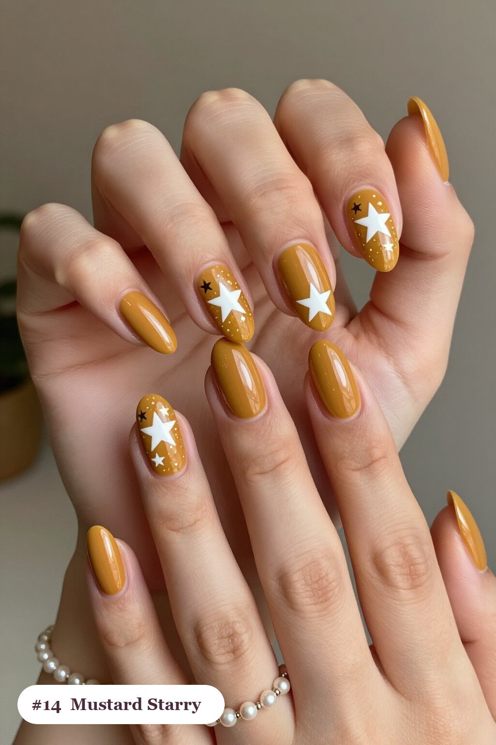 Medium almond mustard nails with white and gold stars and sparkles painted on every nail, perfect for fall - fall almond nails designs
