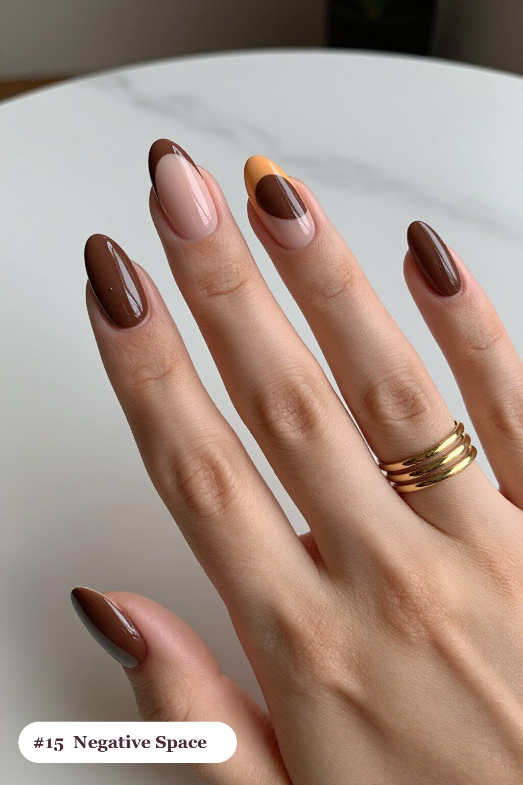 Medium almond chocolate brown nails in a negative-space design with sheer nude windows and bold colour shapes, perfect for fall - fall almond nails designs