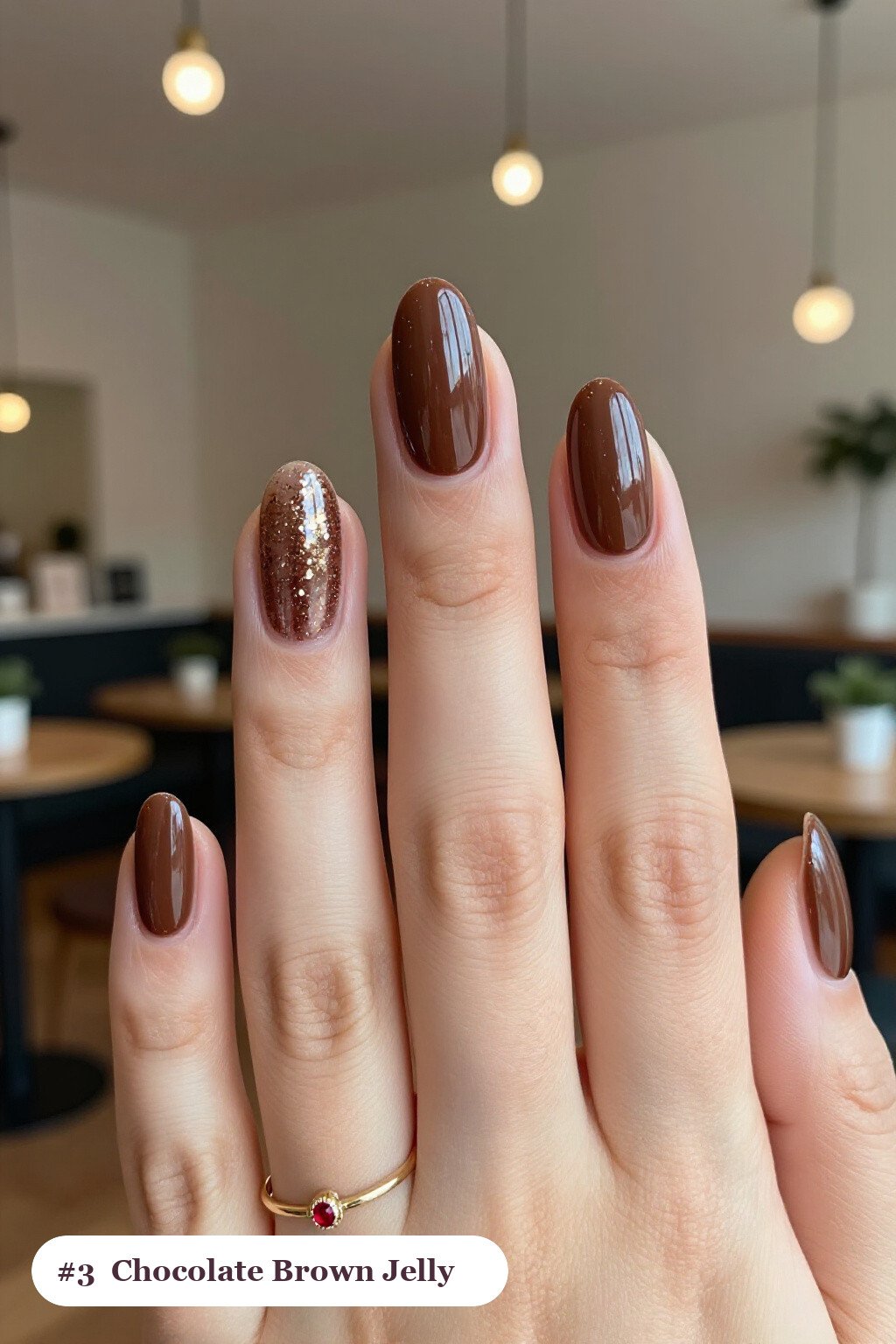 Medium almond chocolate brown nails in a see-through jelly finish with encapsulated glitter, perfect for fall - fall almond nails designs