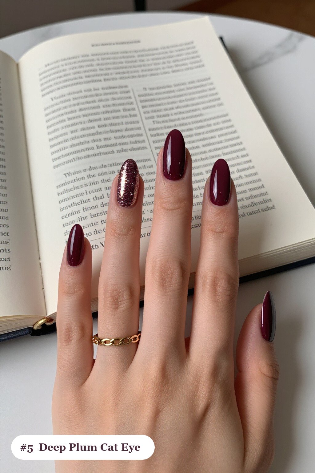 Medium almond deep plum nails with a glowing shimmer band of light running down the centre of each nail like a gemstone, perfect for fall - fall almond nails designs
