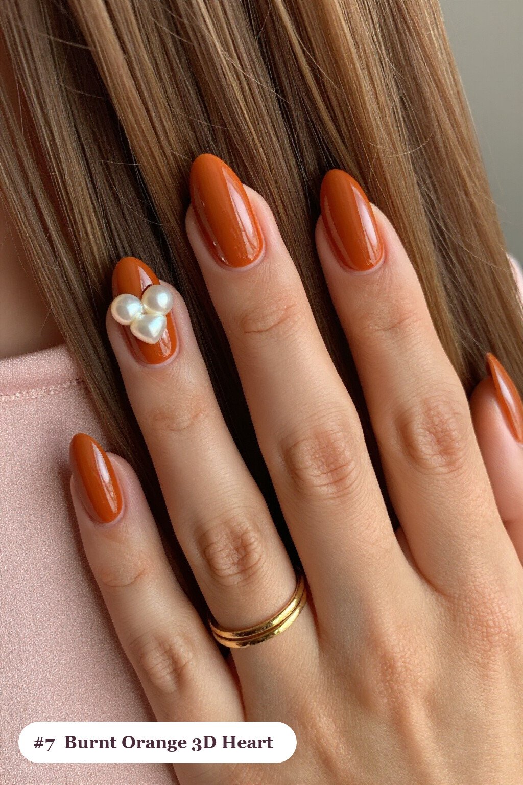 Medium almond burnt orange nails with chunky 3D gel hearts and pearls on three nails, perfect for fall - fall almond nails designs
