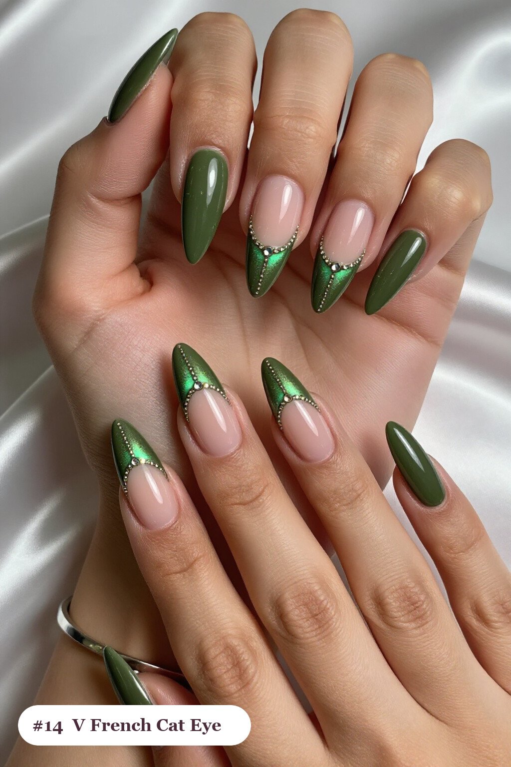 Long stiletto olive green cateye nails with a glowing magnetic cat eye shimmer band running down the centre of each nail like a gemstone clearly visible on every nail, styled with deep V-shaped french tips in a bold contrasting colour, perfect for fall - fall cateye nails Long stiletto olive green cateye nails with a glowing magnetic cat eye shimmer band running down the centre of each nail like a gemstone clearly visible on every nail, styled with deep V-shaped french tips in a bold contrasting colour, perfect for fall - fall cateye nails
