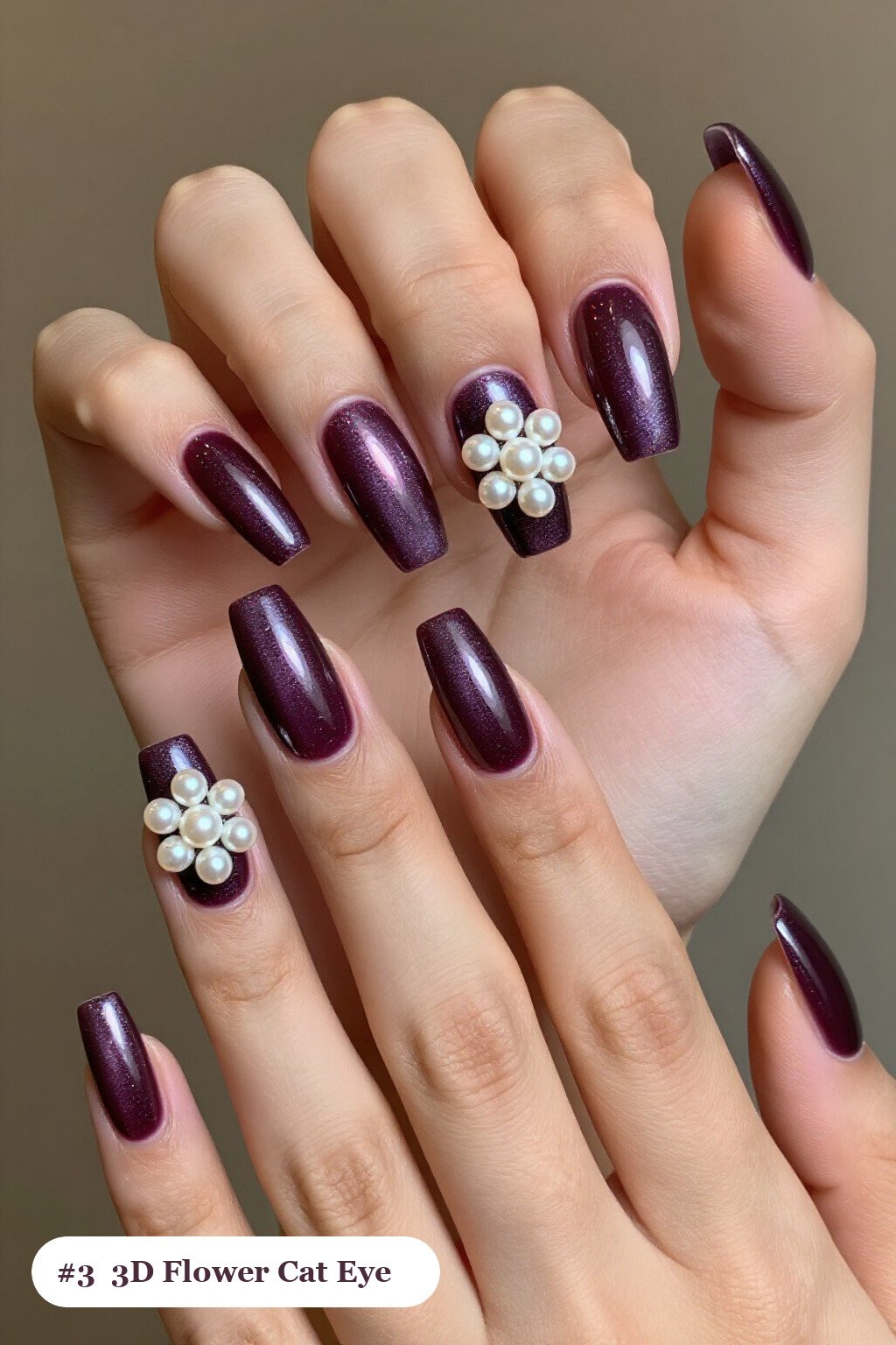 Long square deep plum cateye nails with a glowing magnetic cat eye shimmer band running down the centre of each nail like a gemstone clearly visible on every nail, styled with raised 3D flowers with pearl centres on two accent nails, perfect for fall - fall cateye nails Long square deep plum cateye nails with a glowing magnetic cat eye shimmer band running down the centre of each nail like a gemstone clearly visible on every nail, styled with raised 3D flowers with pearl centres on two accent nails, perfect for fall - fall cateye nails