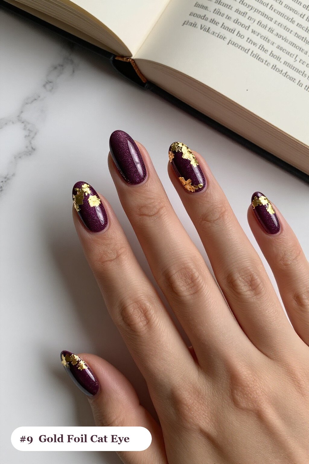 Medium oval deep plum cateye nails with a glowing magnetic cat eye shimmer band running down the centre of each nail like a gemstone clearly visible on every nail, styled with dense gold foil flakes and gold leaf scattered across every nail, perfect for fall - fall cateye nails Medium oval deep plum cateye nails with a glowing magnetic cat eye shimmer band running down the centre of each nail like a gemstone clearly visible on every nail, styled with dense gold foil flakes and gold leaf scattered across every nail, perfect for fall - fall cateye nails