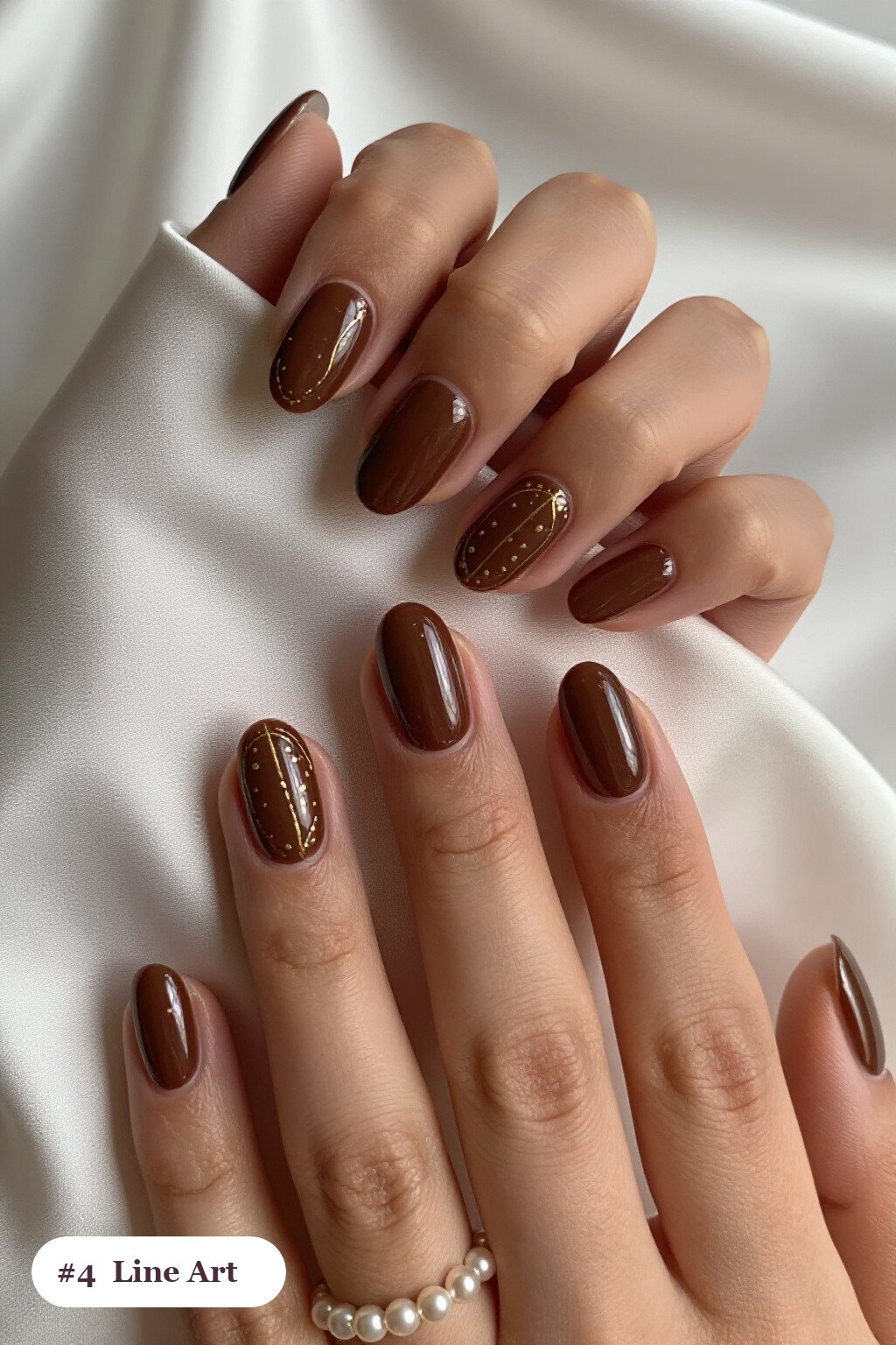 Chocolate Brown Medium Oval Nails with Gold Line Art and Dots - fall manicure ideas