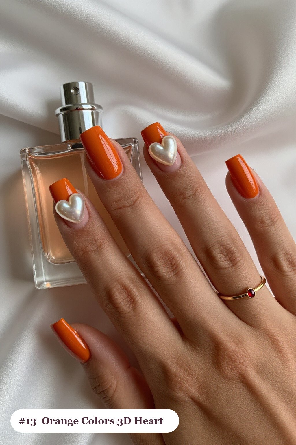 Medium square burnt orange colors nails with chunky 3D gel hearts and pearls on three nails, perfect for fall - fall nail colors