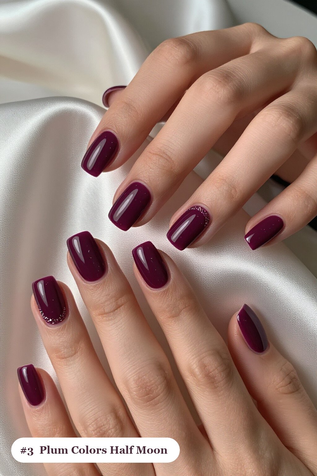 Medium square deep plum colors nails in a half-moon design with a glitter crescent at the cuticle, perfect for fall - fall nail colors