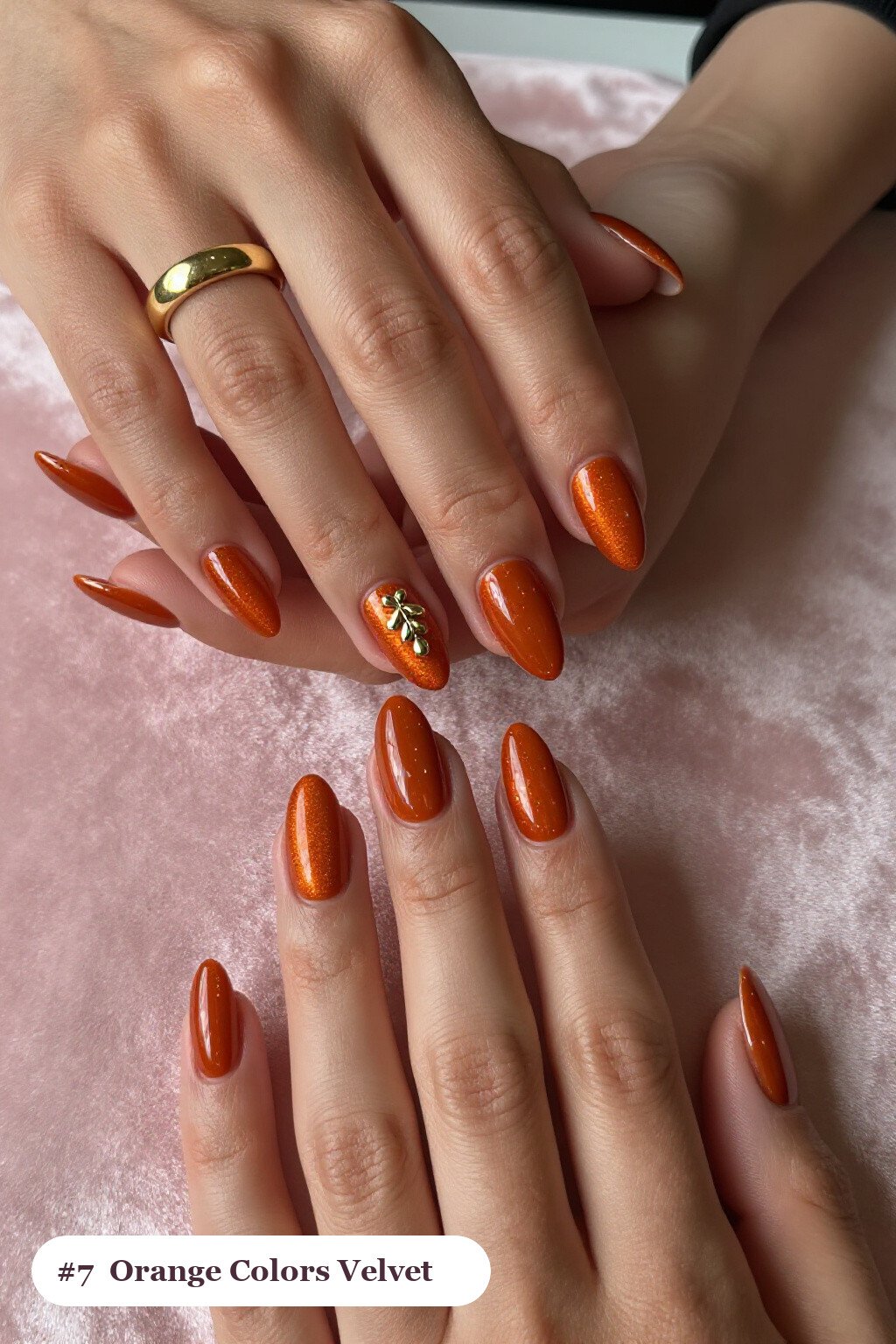 Medium almond burnt orange colors nails in a velvet shimmer finish with one glossy accent nail with a gold charm, perfect for fall - fall nail colors