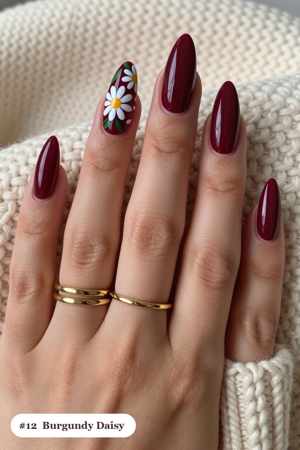 Long stiletto burgundy nails with hand-painted daisies and green leaves across every nail, perfect for fall - fall nails cute