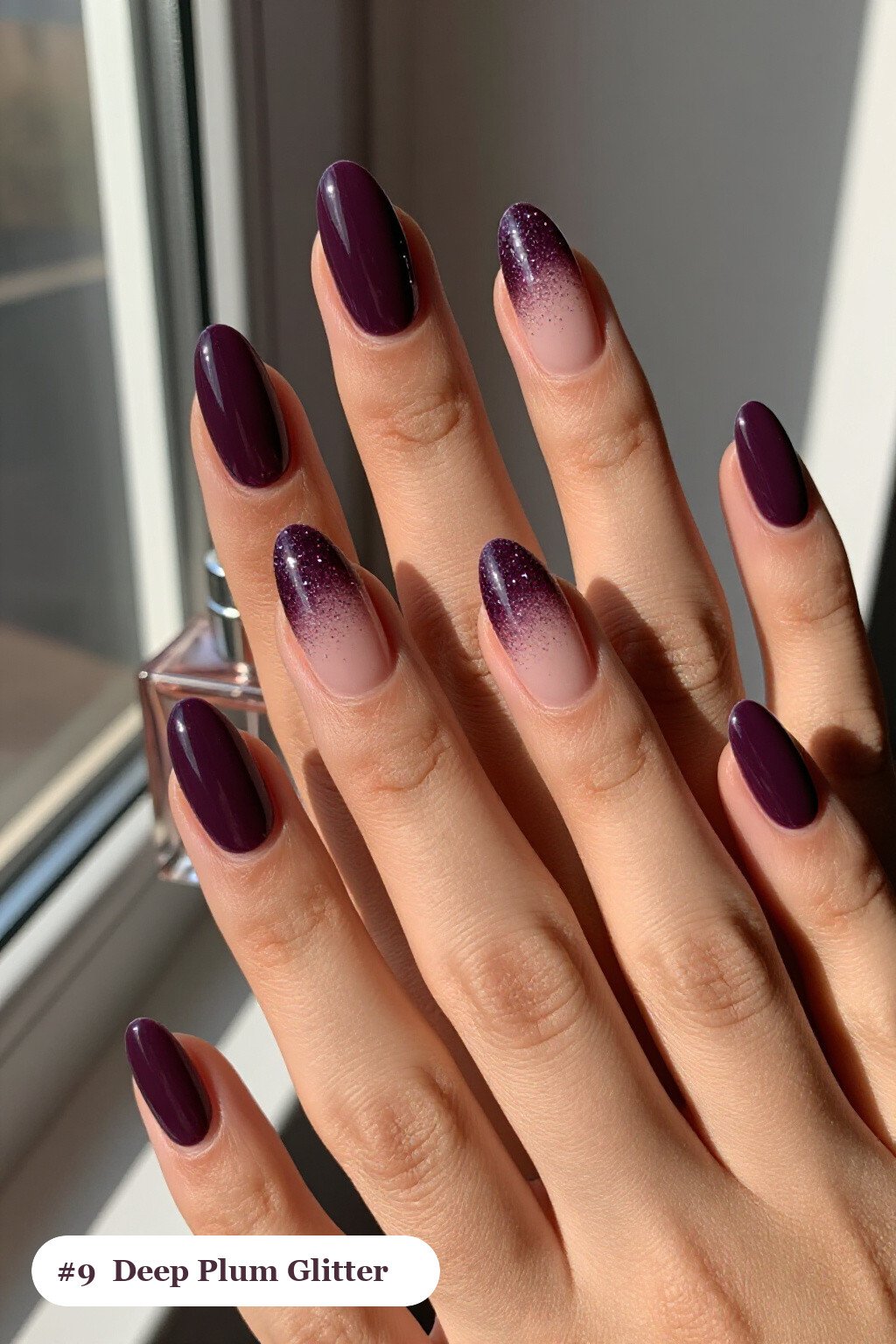 Short almond deep plum nails with a sparkling glitter gradient rising from the cuticle, perfect for fall - fall nails short