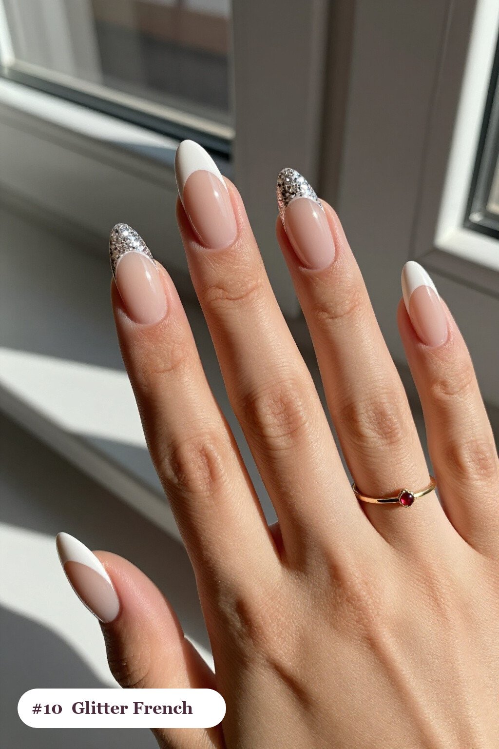 Medium almond bone white nails with glitter-packed french tips over a sheer nude base, perfect for halloween - halloween almond nails