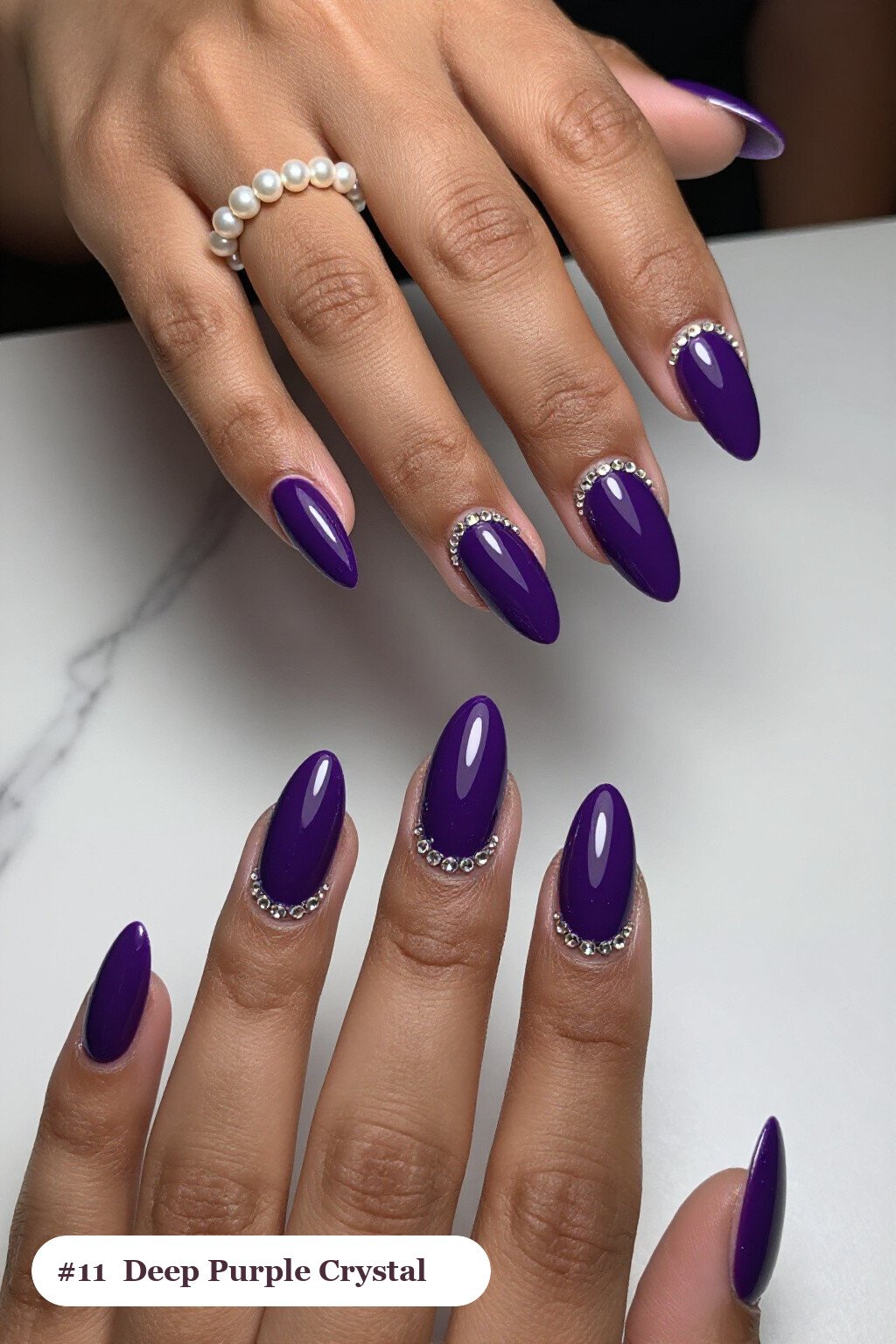 Medium almond deep purple nails with rows of sparkling crystal rhinestones along the cuticle of every nail, perfect for halloween - halloween almond nails