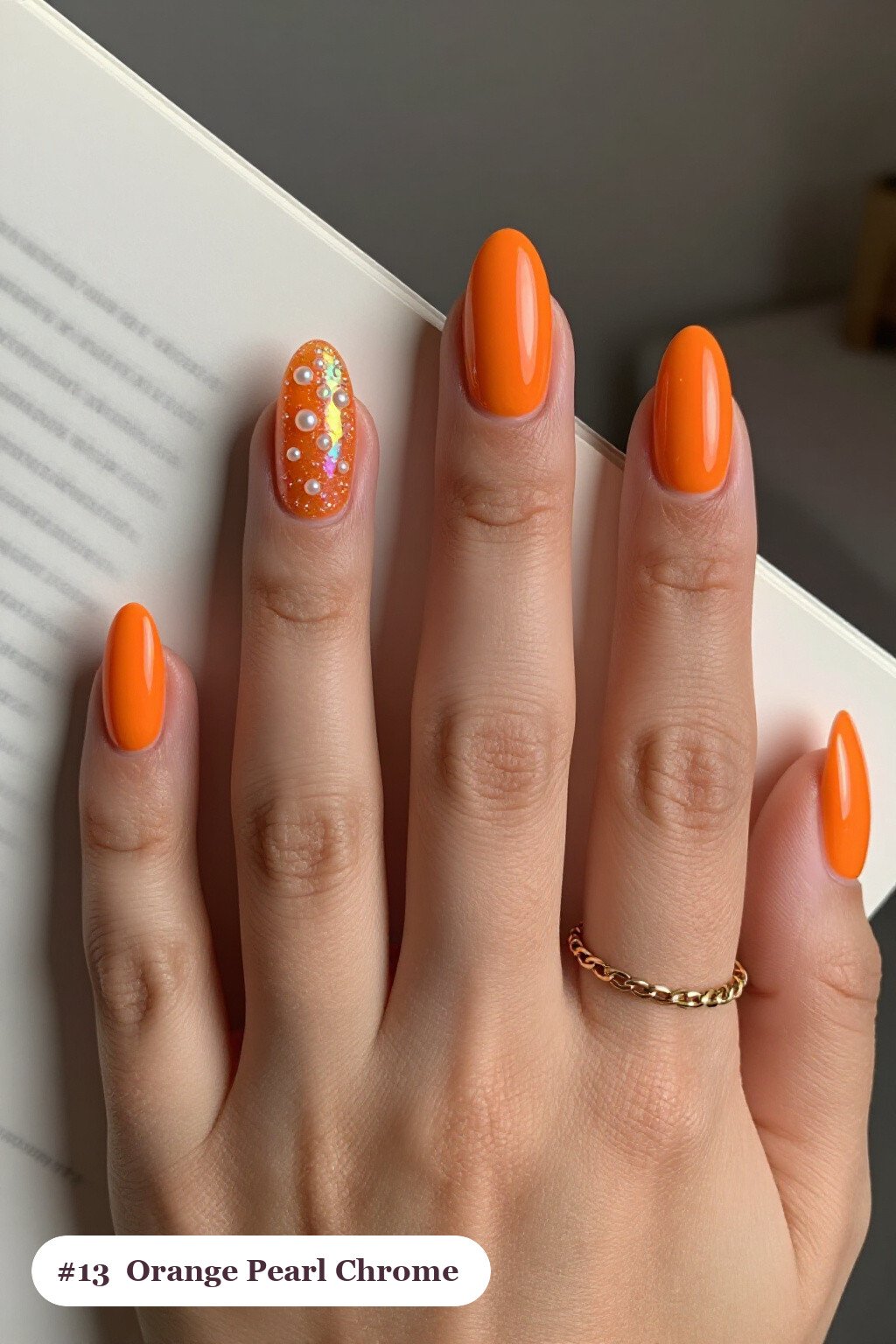 Medium almond orange nails with glazed pearl chrome over the colour for an iridescent sheen, perfect for halloween - halloween almond nails