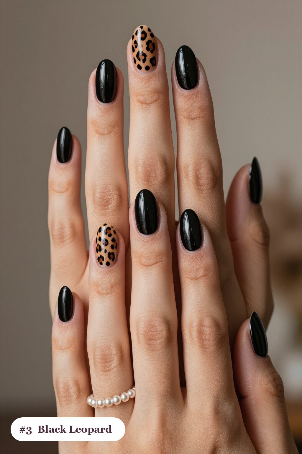 Medium almond black nails with a leopard print pattern on two accent nails and solid colour on the rest, perfect for halloween - halloween almond nails