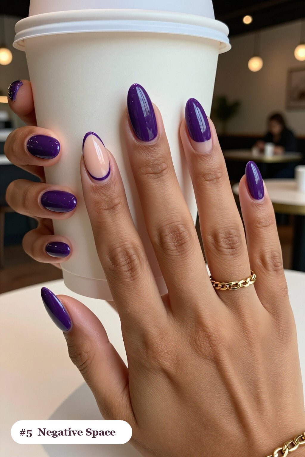 Medium almond deep purple nails in a negative-space design with sheer nude windows and bold colour shapes, perfect for halloween - halloween almond nails